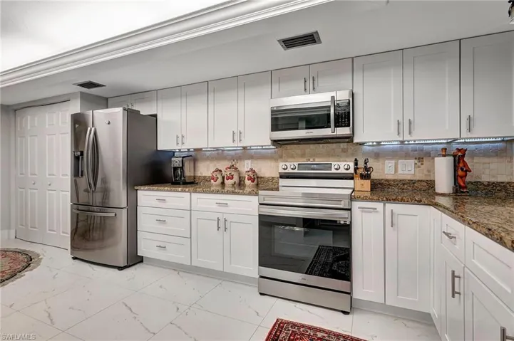 Soft close cabinets, designer kitchen.  New stainless steel appliances. Includes lazy Susan for pots and pans and built in spice rack.