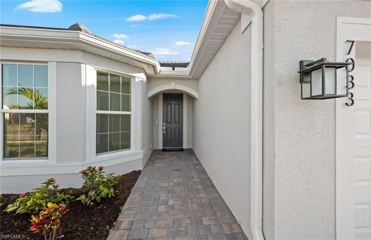 Property entrance featuring stucco siding