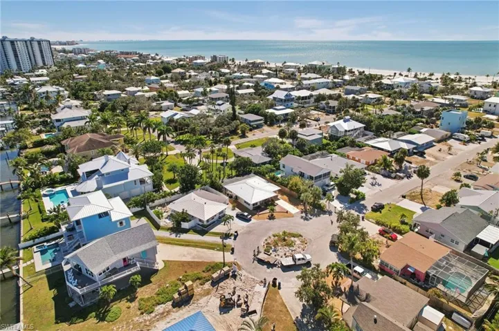 Aerial perspective of suburban area featuring a nearby body of water