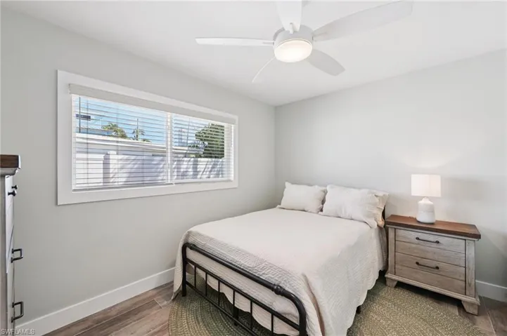 Bedroom featuring dark wood-type flooring and ceiling fan