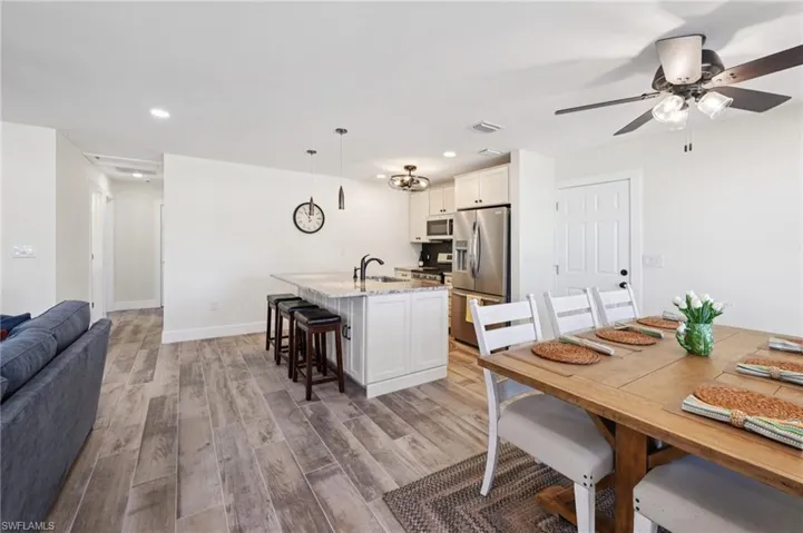 Dining room featuring light wood finished floors, recessed lighting, and ceiling fan