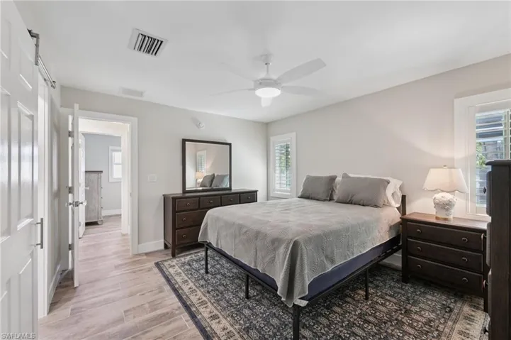 Bedroom featuring light wood-style flooring and a ceiling fan