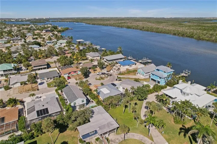 Aerial overview of property's location with a nearby body of water and nearby suburban area