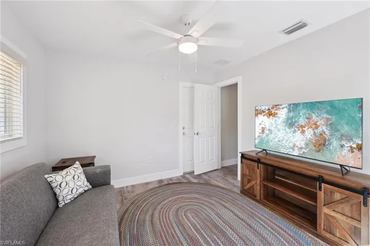 Living area with wood finished floors and a ceiling fan