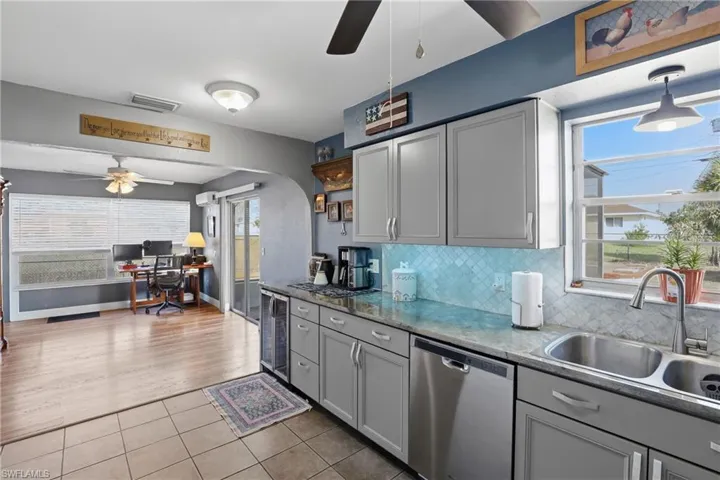 New kitchen cabinets and sleek hardware, marble backsplash and solid surface counters with no grout lines.