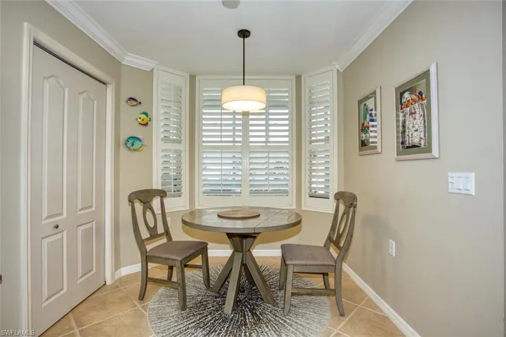 Tiled dining area with crown molding