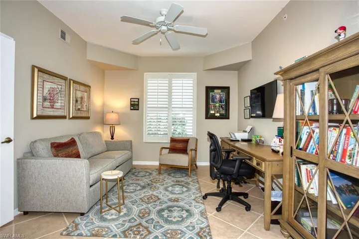 Tiled office featuring ceiling fan