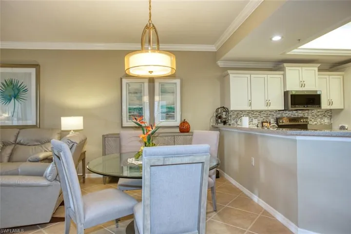 Tiled dining room with crown molding