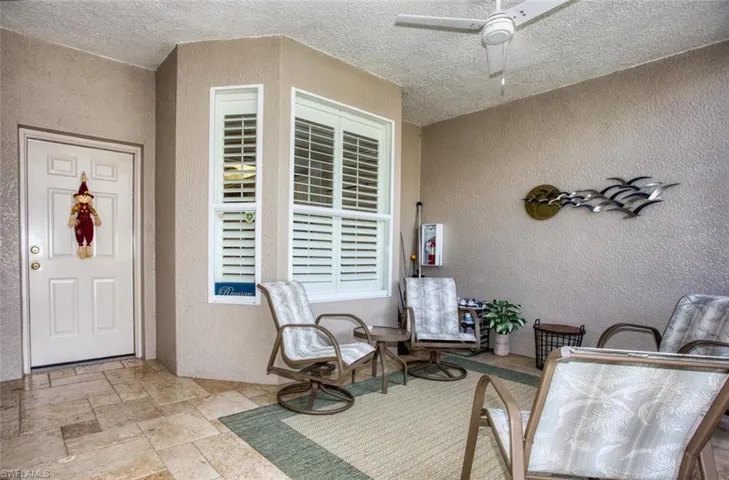 Entrance to property featuring ceiling fan