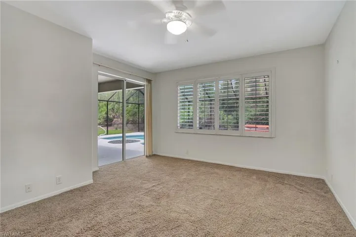Spare room featuring carpet and ceiling fan