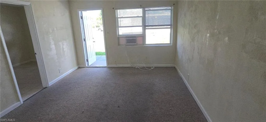Empty room with carpet and cooling unit