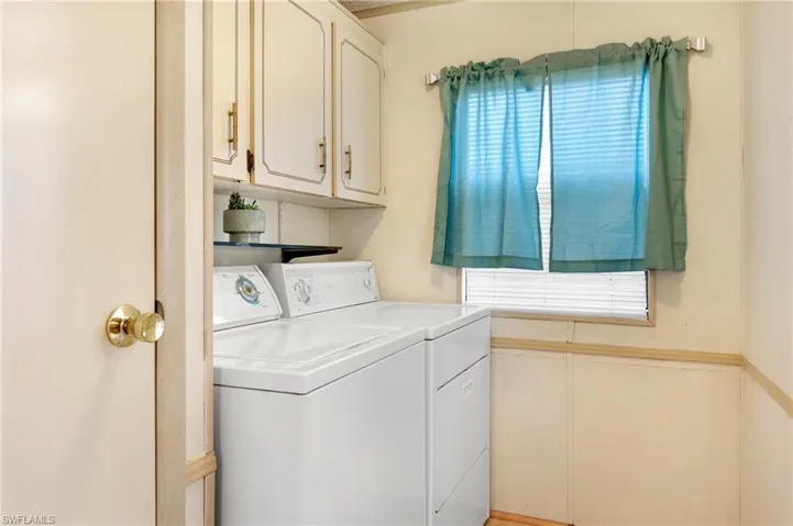 Laundry area with plenty of natural light, cabinet space, and separate washer and dryer