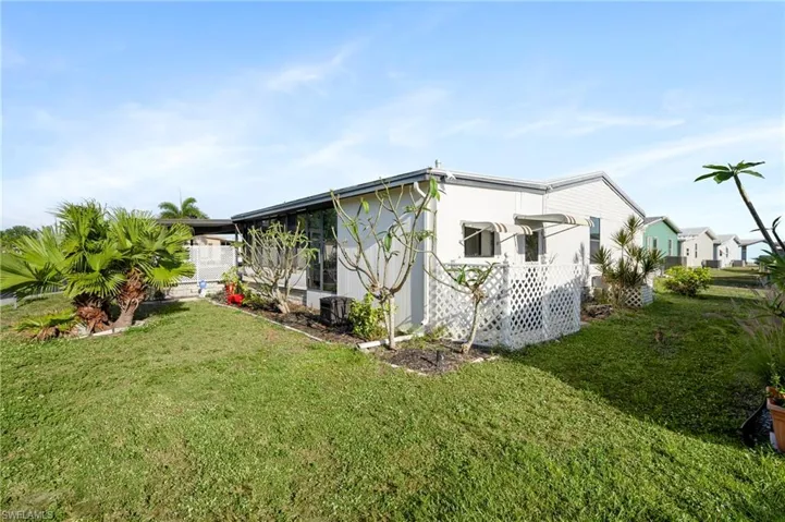 View of side of property featuring a yard
