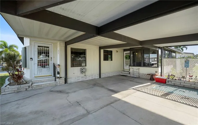 View of patio with an attached carport and entry steps