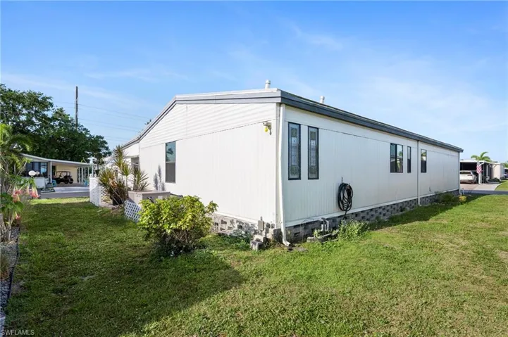 View of side of home with a lawn