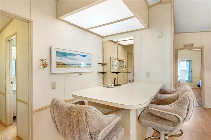 Dining area featuring wet bar and light wood-type flooring
