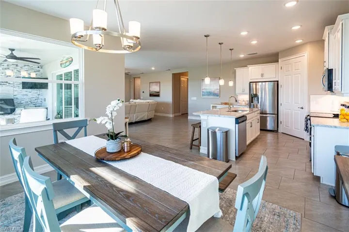 Dining area with a chandelier and ceiling fan