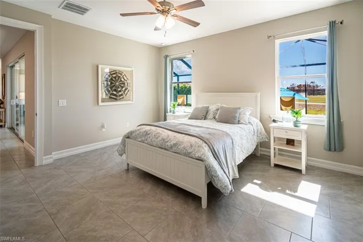 Bedroom with a ceiling fan and light tile patterned floors