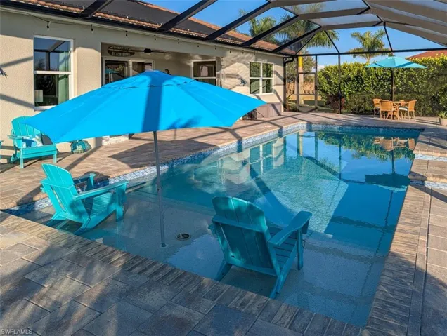 Outdoor pool featuring a patio area, a lanai, a sunroom, and outdoor dining area