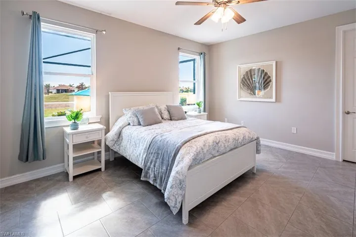 Bedroom with a ceiling fan and light tile patterned floors
