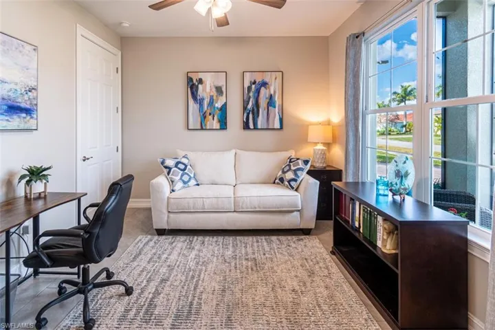 Office with ceiling fan and baseboards