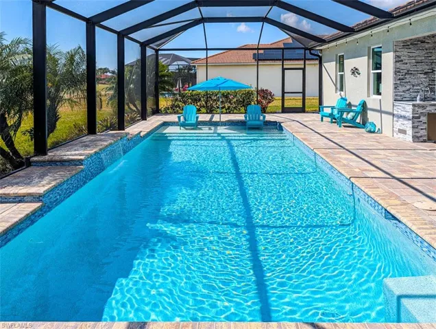 Swimming pool with a lanai, a sunroom, and a patio