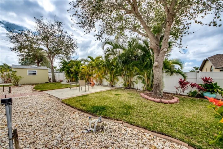 View of yard featuring a patio and a storage unit