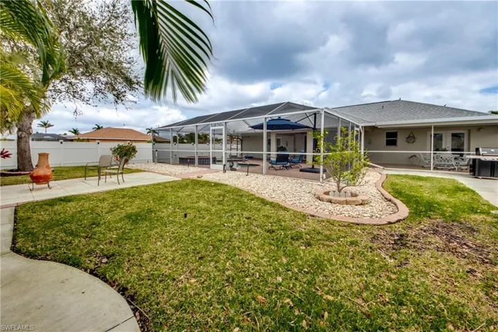 View of yard featuring a patio and glass enclosure