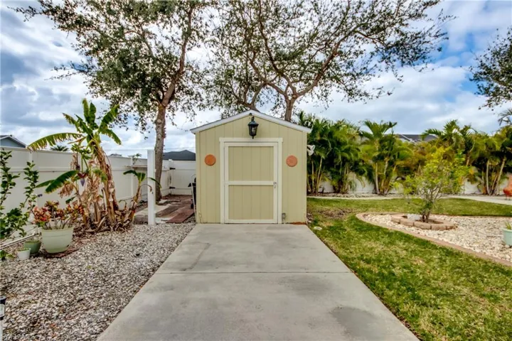 View of outbuilding with a yard