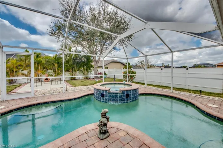 View of pool featuring a lanai, a patio area, and an in ground hot tub