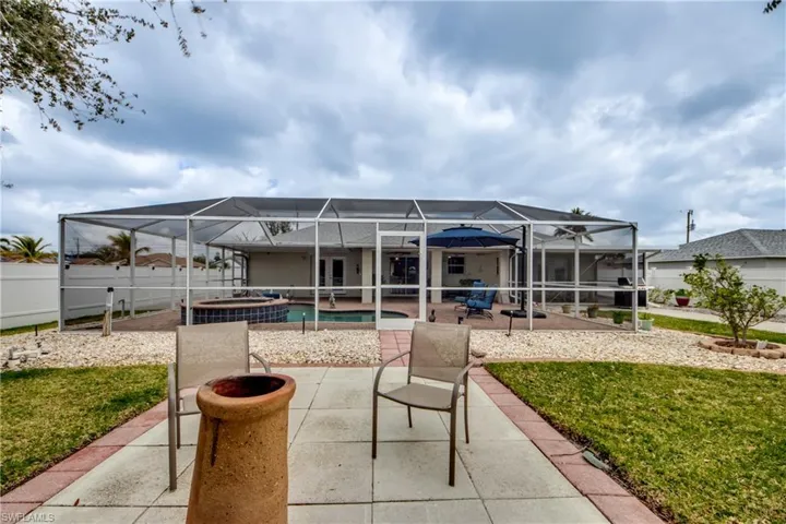 View of patio / terrace with a pool with hot tub and a lanai