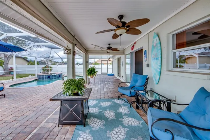 View of patio featuring a fenced in pool, a lanai, and ceiling fan