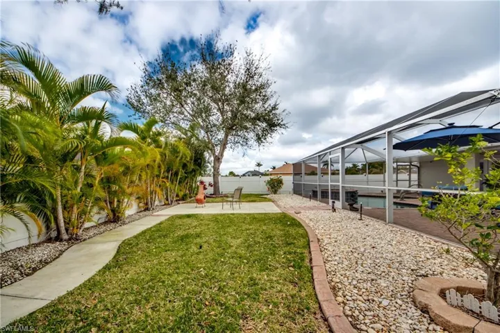 View of yard with a lanai, a fenced in pool, and a patio area