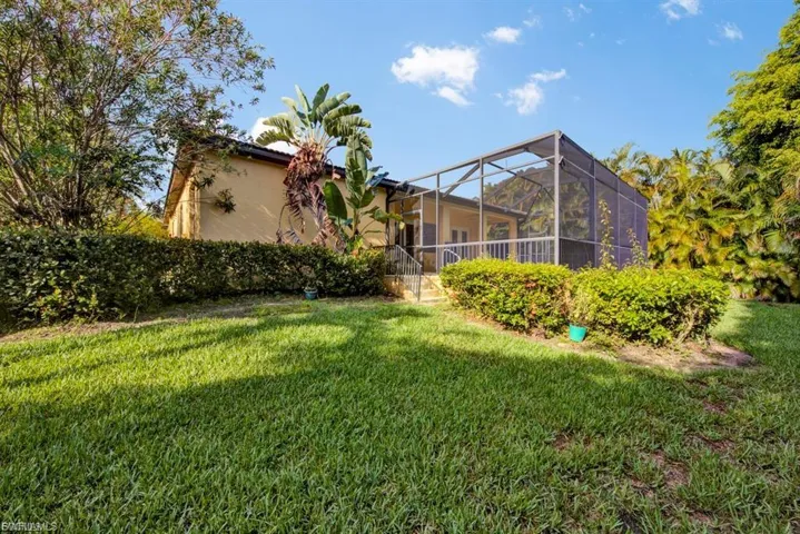View of grassy yard featuring a lanai