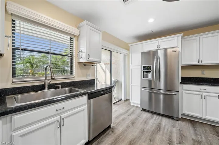 Kitchen with lots of natural light, open to the pool and canal