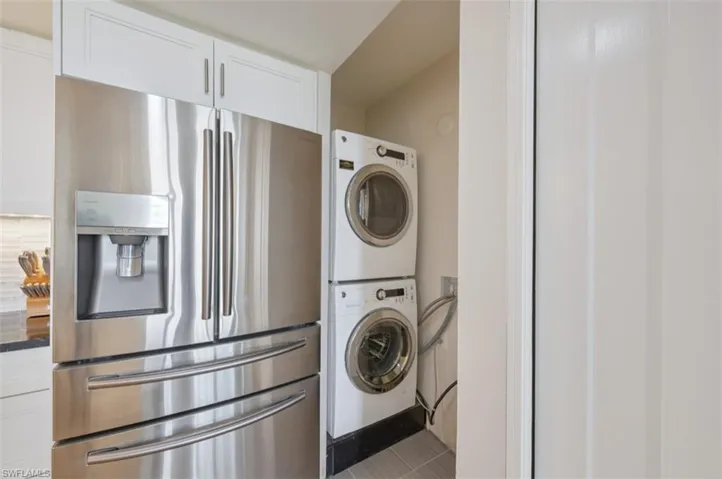 Laundry area featuring stacked washer and dryer