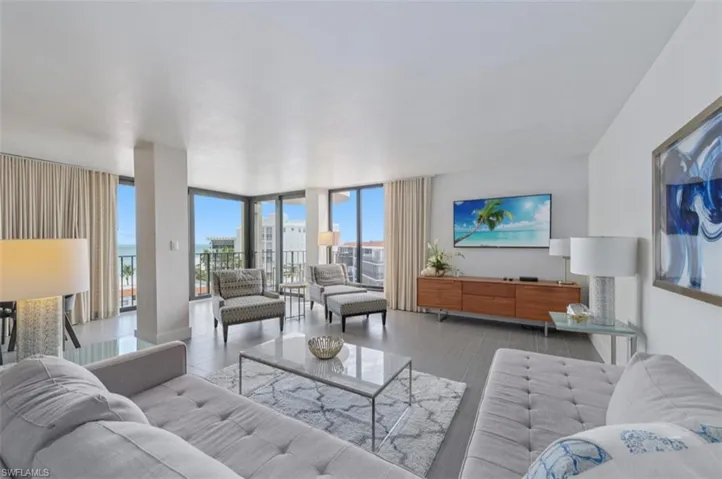 Living area featuring floor to ceiling windows