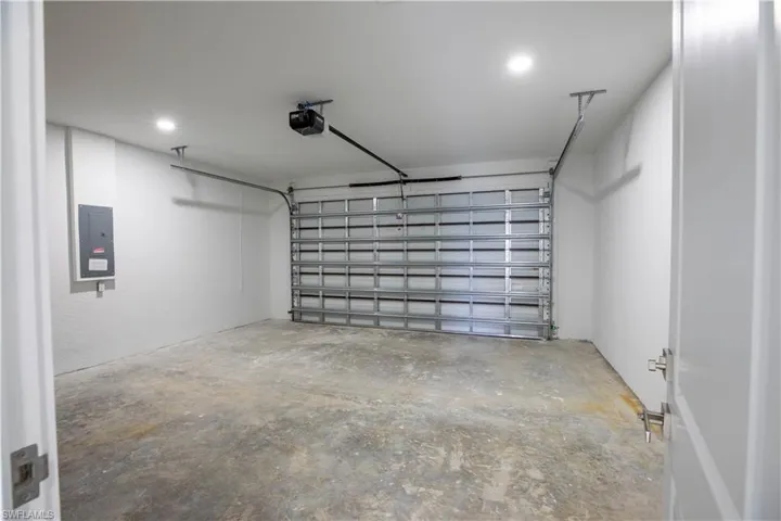 Garage with a garage door opener and electric panel