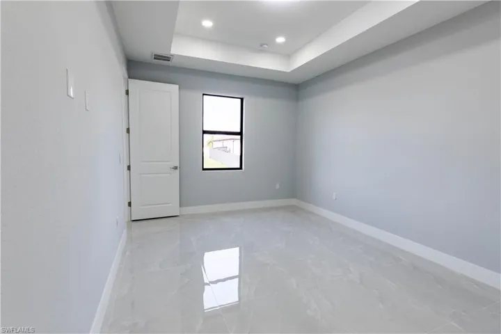 Spare room featuring a tray ceiling