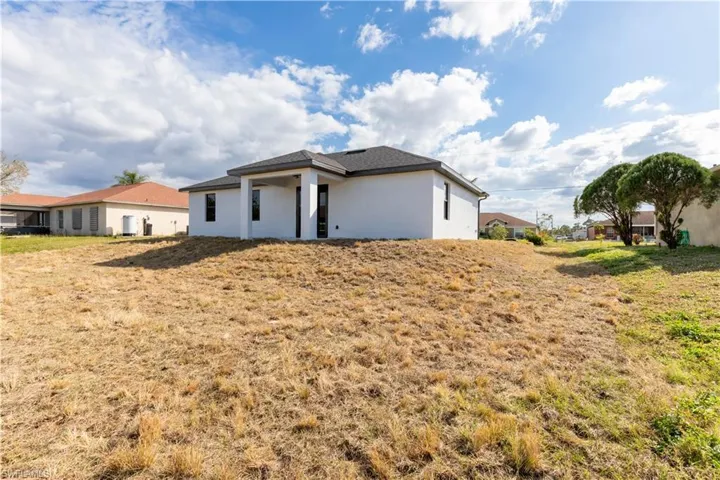 Rear view of property featuring a yard
