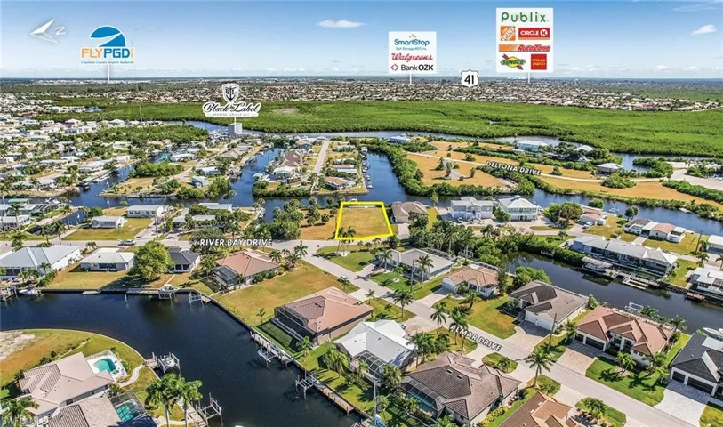Aerial view of residential area featuring a large body of water