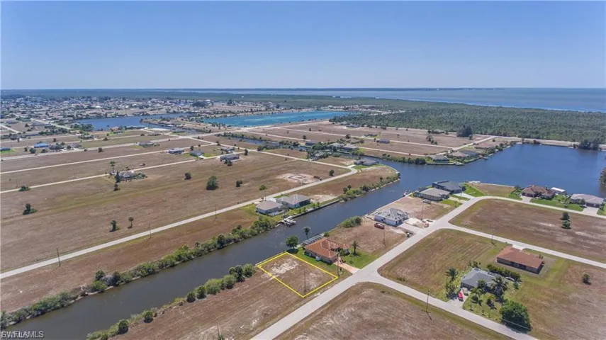 Aerial overview of property's location featuring a large body of water and property parcel outlined