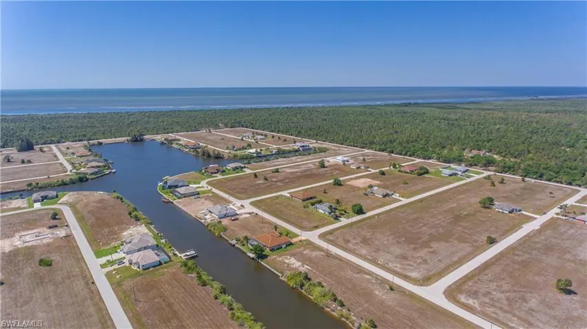 Aerial overview of property's location with a large body of water