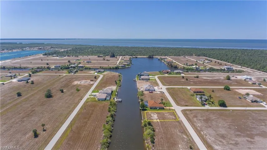 Drone / aerial view of a large body of water and a heavily wooded area
