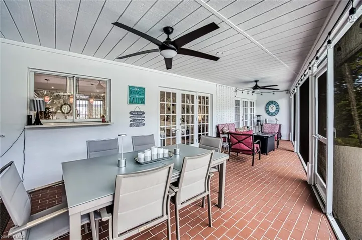 Sunroom / solarium with ceiling fan and french doors