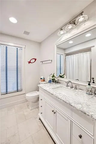 Bathroom featuring vanity, toilet, and a shower with shower curtain