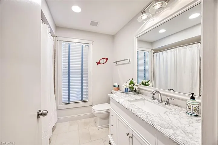 Bathroom featuring vanity and toilet