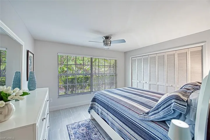 Bedroom featuring ceiling fan and multiple windows