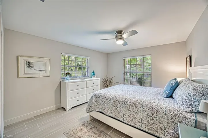Bedroom with multiple windows and ceiling fan