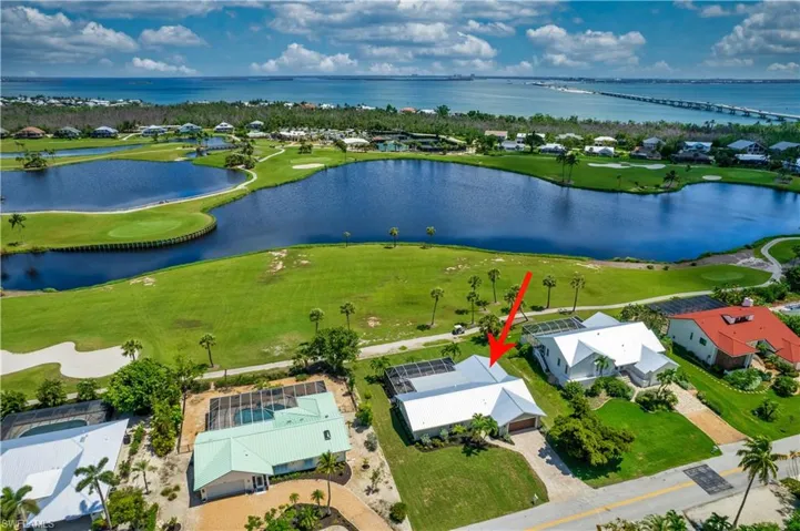 Aerial perspective of suburban area featuring a large body of water and The Dunes Golf Course